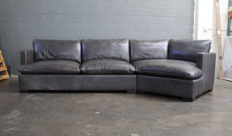 Front view of the Reno Leather Sectional Sofa with Cuddler in Mont Blanc Wolf