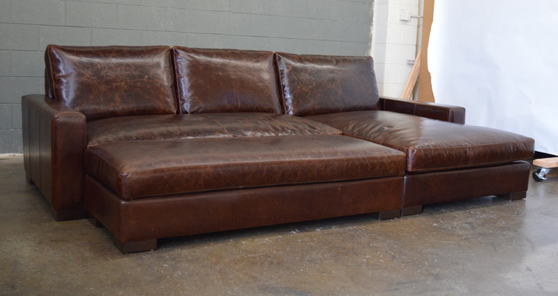 Front left angle view of Braxton Sofa Chaise Sectional shown with Full Fit Cocktail Ottoman