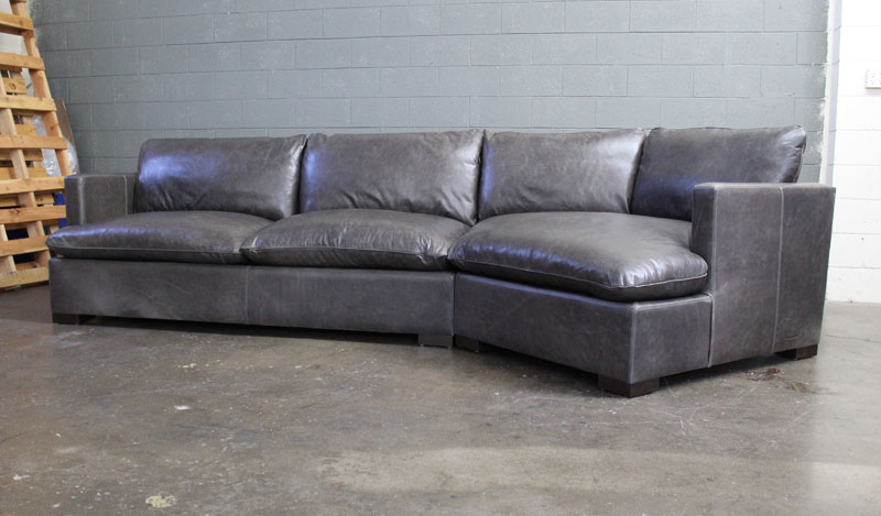 Front angle view of the Reno Leather Sectional Sofa with Cuddler in Mont Blanc Wolf